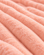 Plaid polaire côtelé Douillette, coloris pêche, gros plan sur la maille côtelée